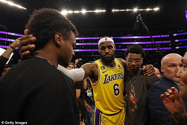 James celebrated the achievement with his sons Bronny (L) and Bryce (R) on Tuesday night