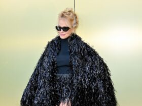 Pamela Anderson Holds Court in Dramatic Coat at Versace Fall 2023 Show – WWD