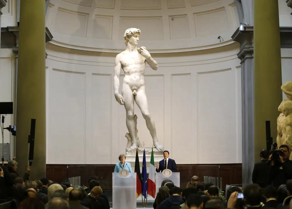 German Chancellor Angela Merkel, left, and Italian Prime Minister Matteo Renzi speak during a press conference in front of Michelangelo’s “David statue” after their bilateral summit in Florence, Italy, Jan. 23, 2015. (AP Photo/Antonio Calanni, File)