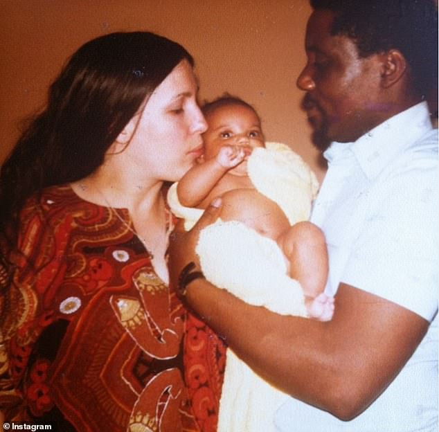 Baby Chioma held by her Swiss-German mother and Nigerian father in London