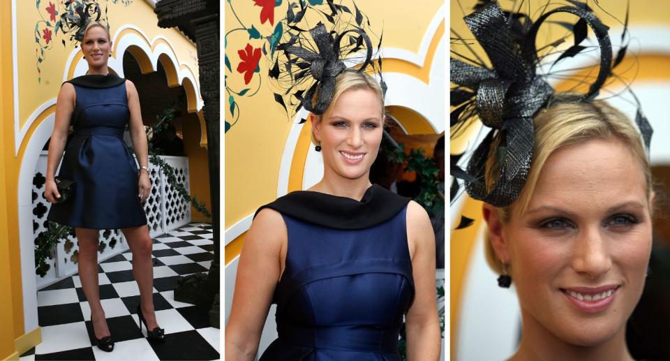 Equestrian Zara Phillips in a blue short dress and black feather fascinator at the Melbourne cup in 2009. 