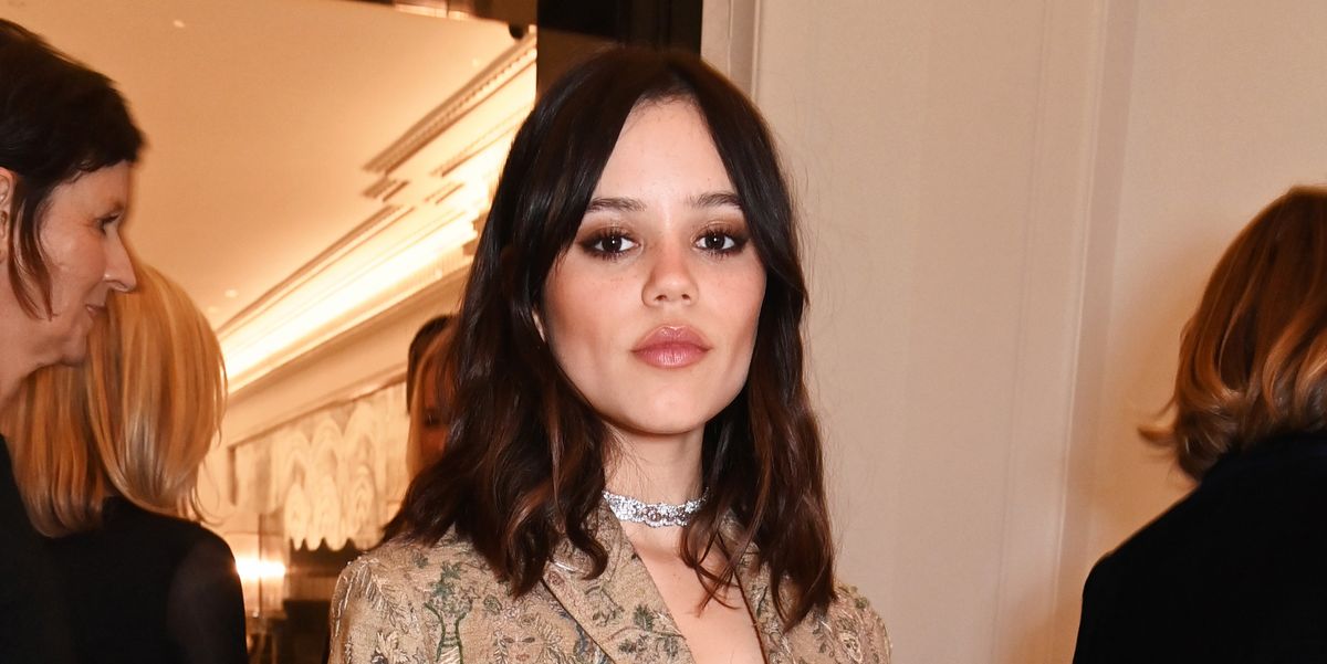 Jenna Ortega wears a sheer gold dress with a carpet coat in London