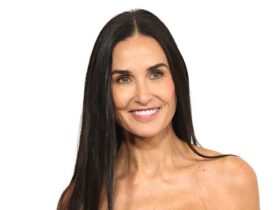 Demi Moore, 60, defies expectations in glitterball dress and vampy waist-length hair