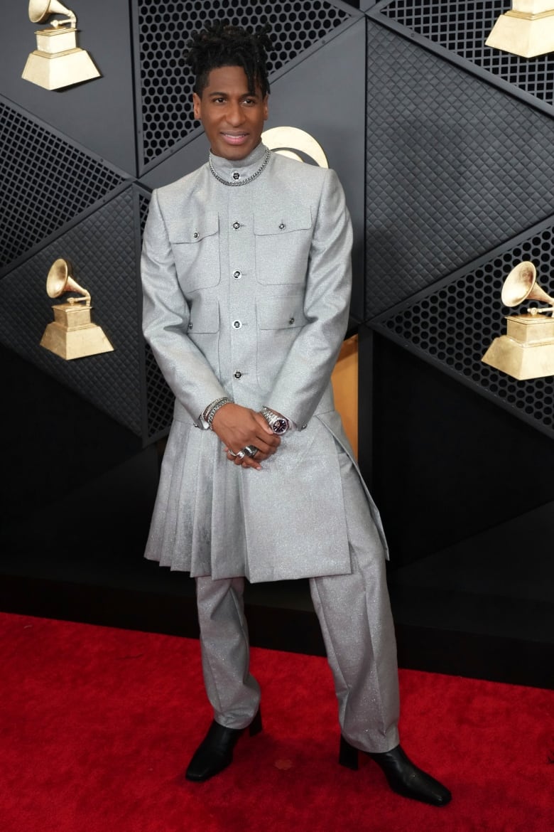 A man wearing a light gray suit.